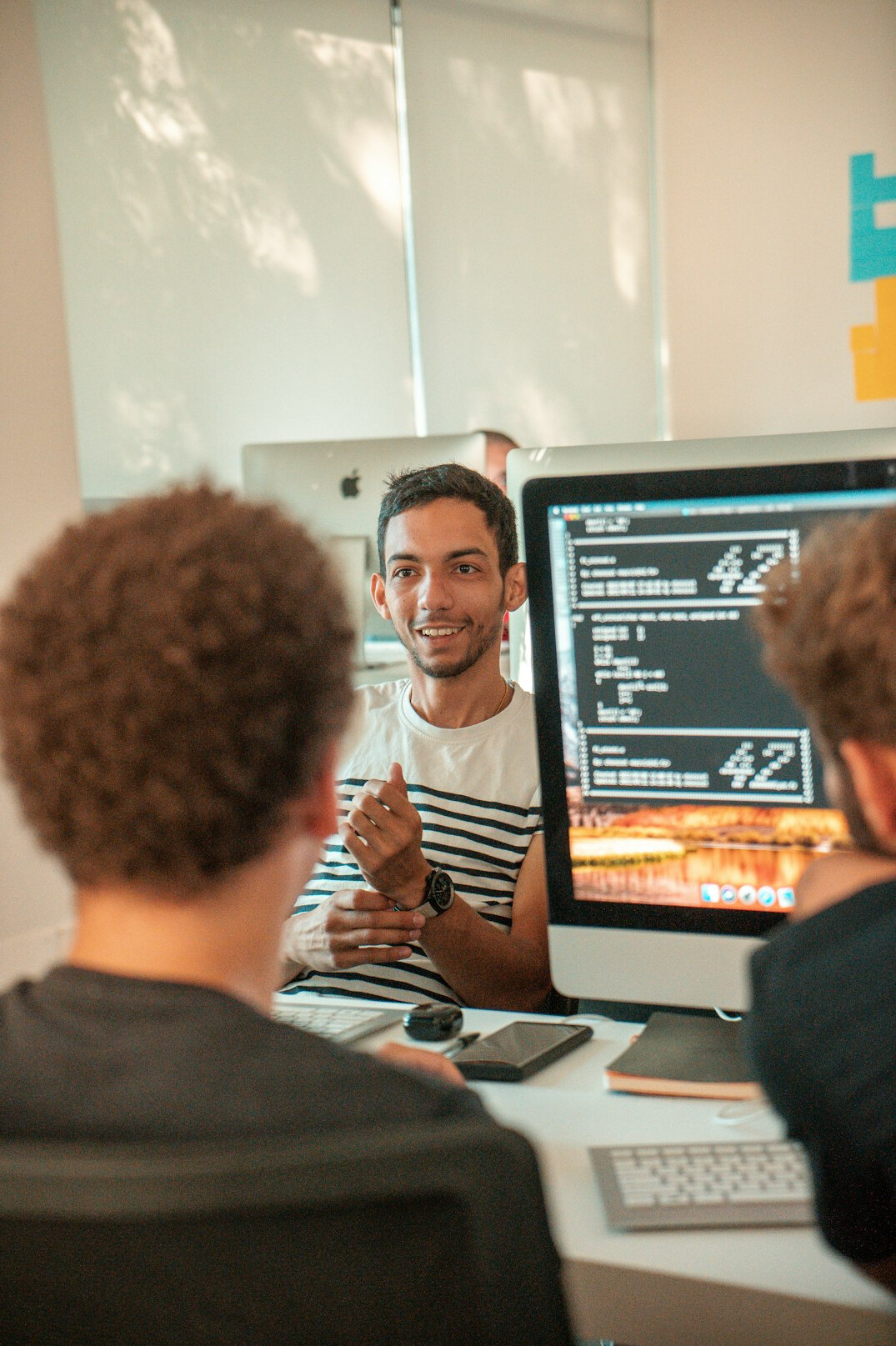 team of programmers collaborating on code