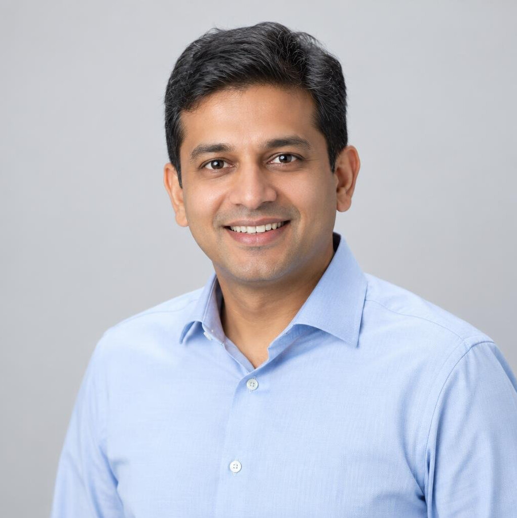 Professional studio portrait of an Indian-Singaporean businessman smiling